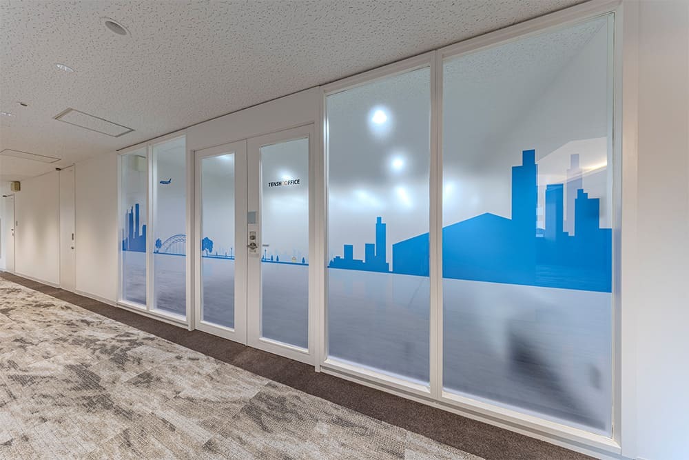 外観_オフィス入口。天王洲アイルの情景を描いたグラフィックが印象的なフロントガラスです。